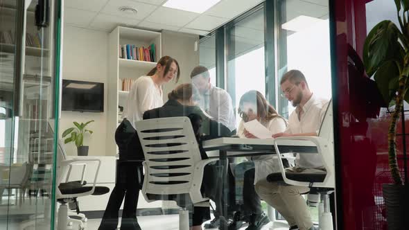 Entrepreneur Explaining New Strategies to Colleagues in Meeting Room