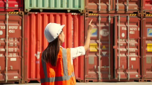 Asian engineer Foreman female worker working checking at Container cargo