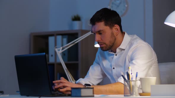 Businessman with Laptop Working at Night Office 33