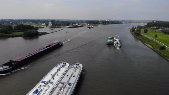 multiple barges sailing on a dutch river