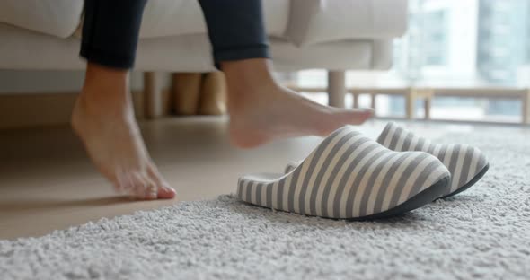 Woman wearing slipper at home