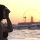 Cheery Girl in Bikini Putting Her Hair in Order on a City Beach at Striking Sunset in Slow Motion - VideoHive Item for Sale