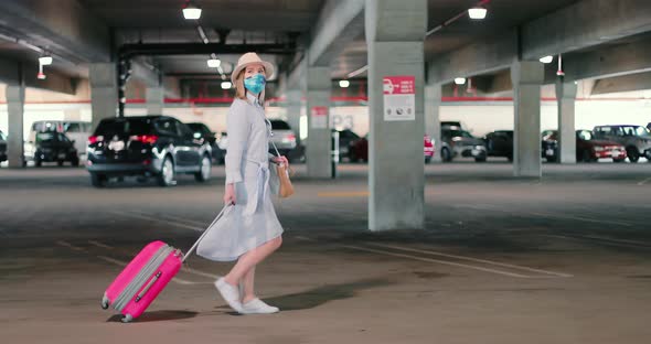 Slow Motion of Woman in Mask Walking By Empty Airport Parking During COVID-19