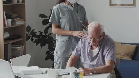 Nurse Examining Senior Man with Stethoscope