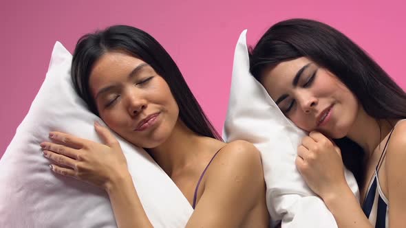 Beautiful Multiethnic Women Sleeping on Pillows Against Pink Background, Dreams