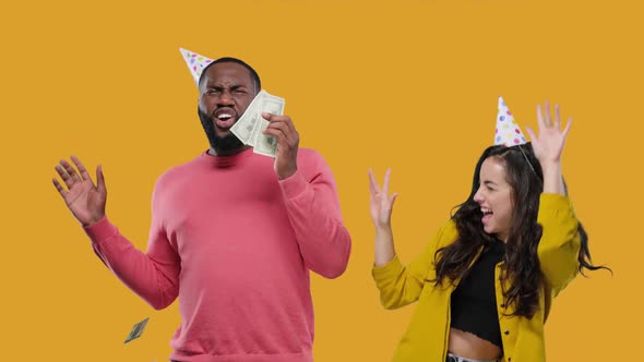 Black Man and White Woman Couple Dancing with Falling in Dollars Financial Business Success