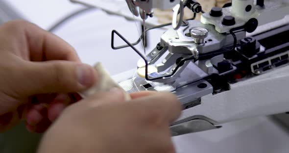 Tailor sewing button on electric sewing machine