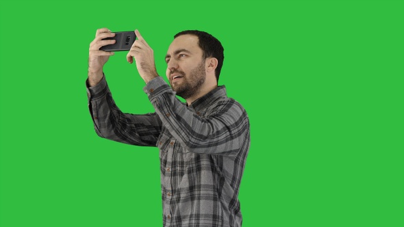 Young man taking a selfie on a Green Screen, Chroma Key