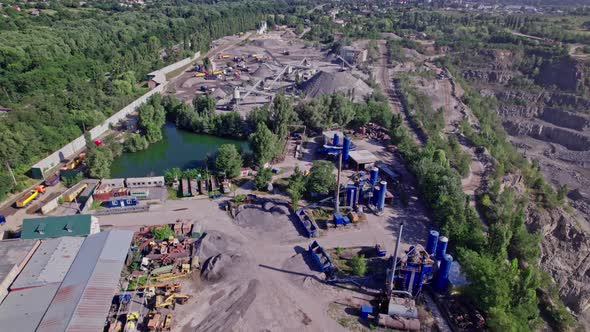 Excavators and Tractors Load Crushed Stone and Rock Into Dump Trucks