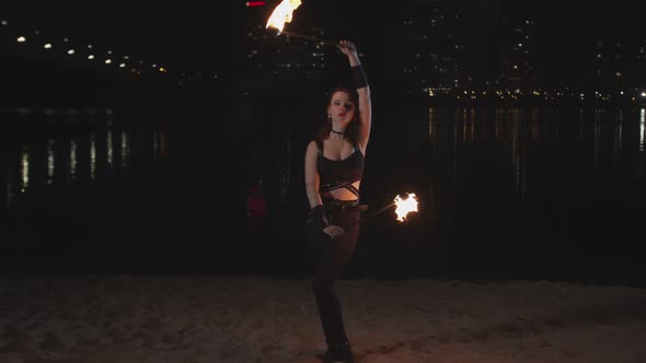 Firegirl Performing Juggling Skill on River Bank