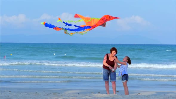 Happy Grandmother with Child the Playing Flying Kite