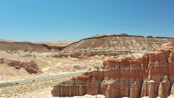 Highway 14 Midland Trail along red sandstone cliffs in the Mojave Desert - aerial view