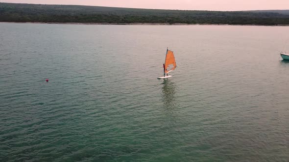 Aerial view of man practicing kitesurfing at transparent water, Croatia.