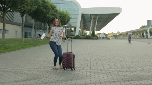 Coronavirus Pandemic, Covid-19 Ended. Woman Tourist Takes Off Medical Mask. Dance, Celebrate