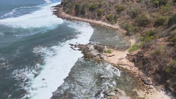 Drone flying over a rocky island of Ixtapa located in the state of Guerrero, Mexico during a sunny d