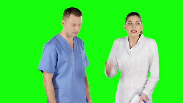 Two Young Doctors Debating. Green Screen