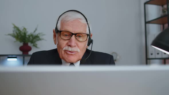 Senior Old Businessman Wearing Headset Working in Office Call Center Conference Support Agent