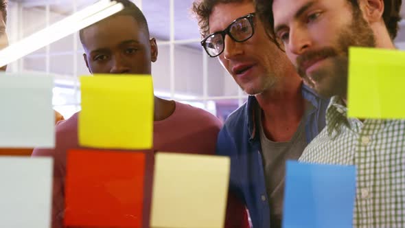 Group of business executives interacting over sticky notes