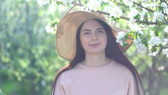 Beauty Young Woman Enjoying Apple Blooming Spring Orchard.