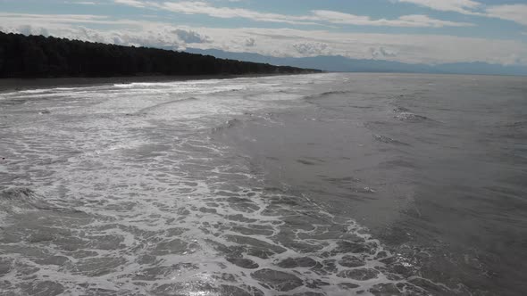 Drone flying over of big waves in Shekvetili sand beach