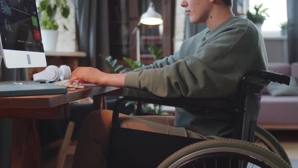 Paraplegic Woman on Wheelchair Working on Computer at Home