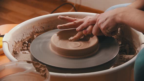 Pottery -The Master Is Removing Clay From the Bottom of the Clay Bowl