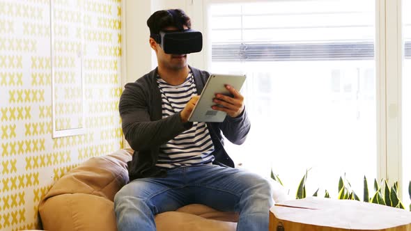 Business executive using virtual reality headset and digital tablet