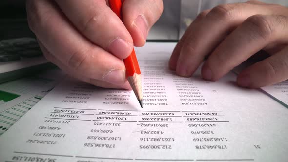 Accountant Analyzing Business Marketing Data on Paper Dashboard at Office Table