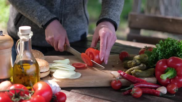 Woman Cuts Tomatoes Making Vegetable Salad Outdoors