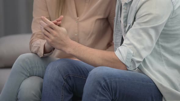 Loving Couple Gently Interlacing Their Fingers and Kissing at Home, Romantic