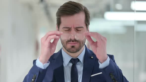 Exhausted Young Businessman Having Headache