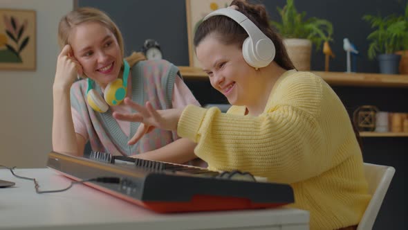 Girl with Down Syndrome Playing Synthesizer with Music Teacher