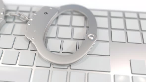 Handcuffs on Keyboard with PORN Text on Keys