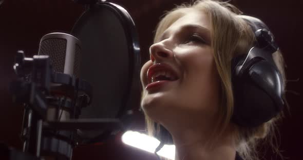 Beautiful Woman Sings a Love Song in Recording Studio