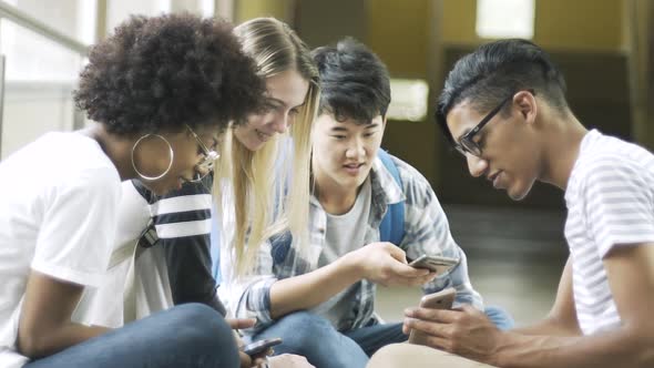 Teenage friends talking and using phone