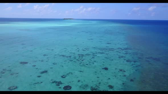 Aerial drone scenery of relaxing seashore beach time by blue green lagoon with white sand background