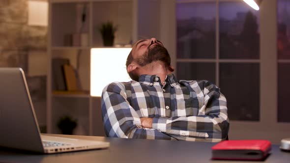 Businessman Sleeping on Chair in Home Office