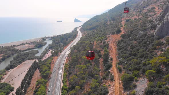 Close-up Flight Next To the Uphill Funicular with the Coast in the Background 