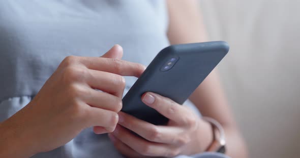 Woman use of mobile phone at home