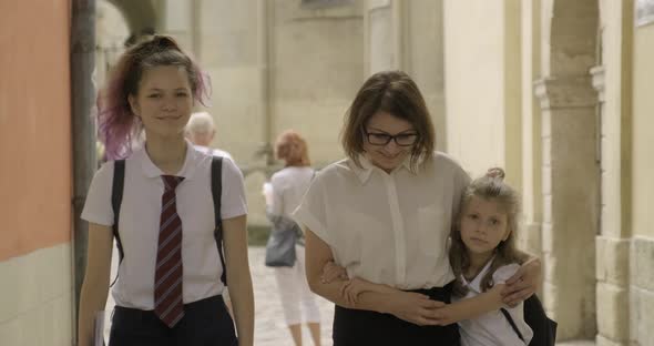 Mother and Two Daughters Students Walking Together