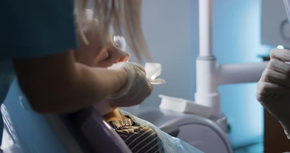 Brave Little Girl in Chair During Dental Procedure