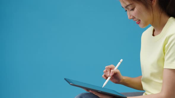 Young girl using digital tablet looking at empty space isolated .