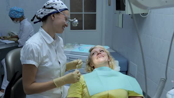 The Dentist Uses Dental Equipment to Examine the Patient's Teeth