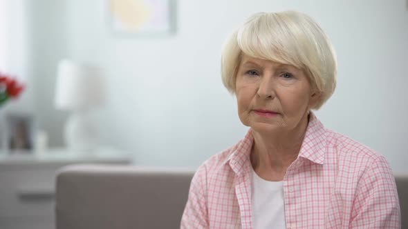 Depressed Senior Woman Looking at Camera