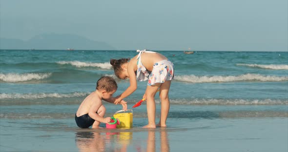 Happy and Carefree Children Playing By the Sea with Sand . Children Playing, Brother and Sister Play