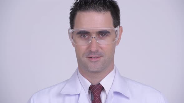 Face of Happy Handsome Man Doctor Smiling and Wearing Protective Glasses