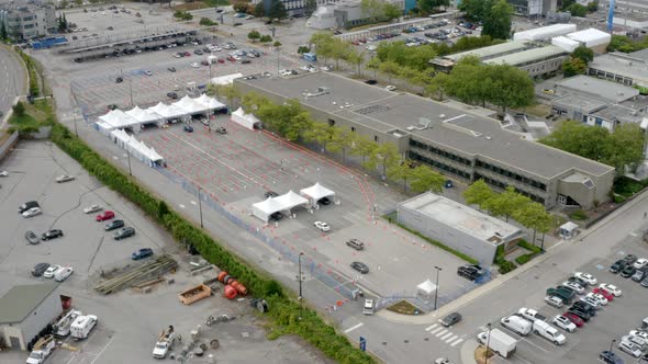 Aerial View Of Vehicles Driving On Tents At Drive-Thru COVID-19 Vaccine Site.