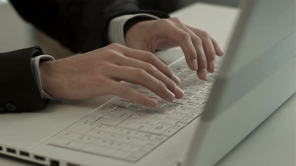 Man Typing on Laptop Computer Keyboard