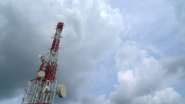 Large telecommunication tower against sky and clouds in background