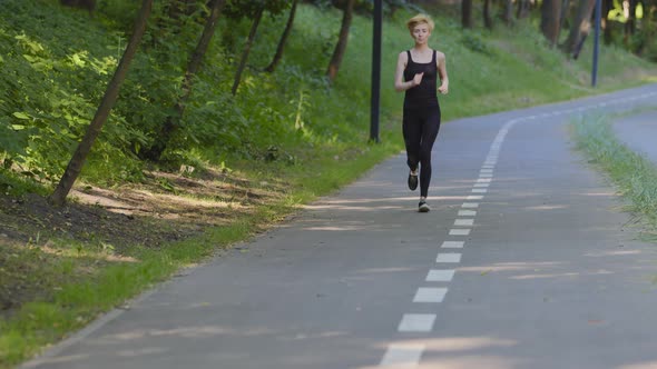 Slender Strong Active Athletic Middle Aged Caucasian Woman Jogger Lady Female Runner Wears Black